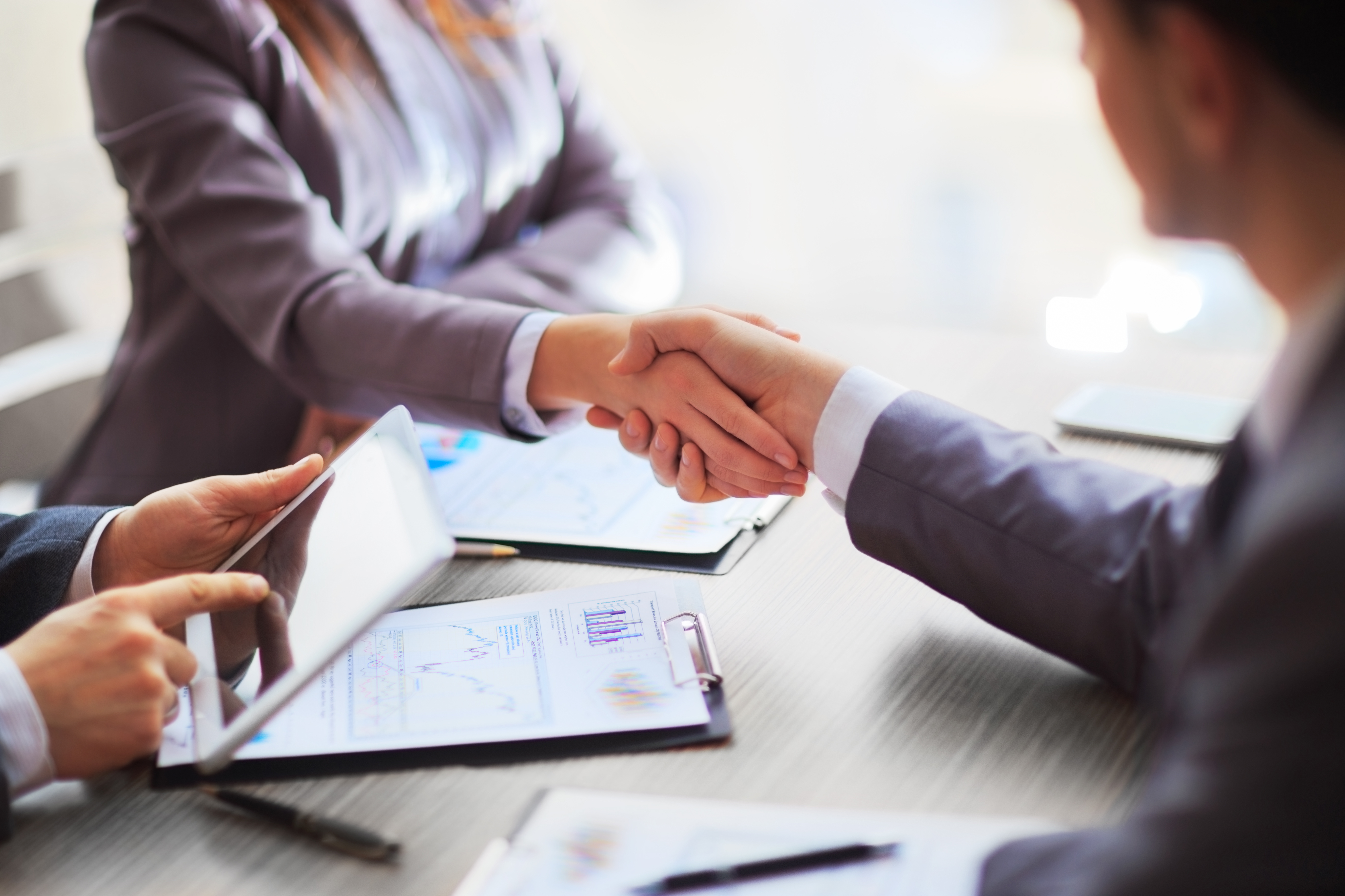 Business people shaking hands, finishing up a meeting