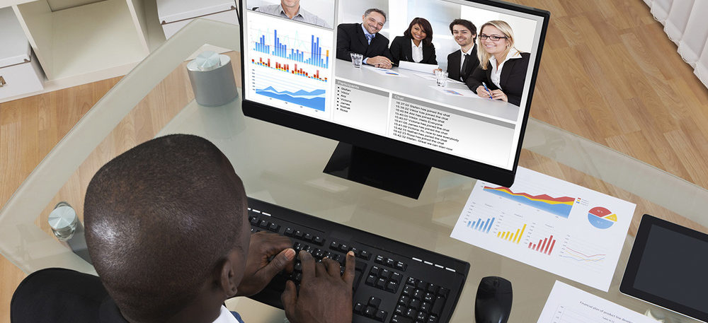 High Angle View Of Businessman Video Conferencing With Colleague On Computer In Office